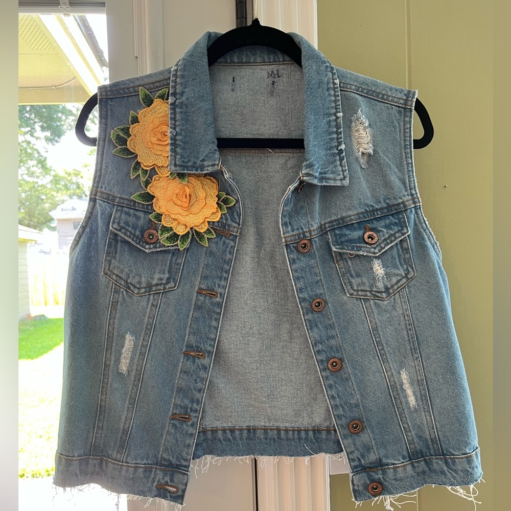 Thrifted treasure! Lightly distressed denim vest w beautiful yellow floral flare